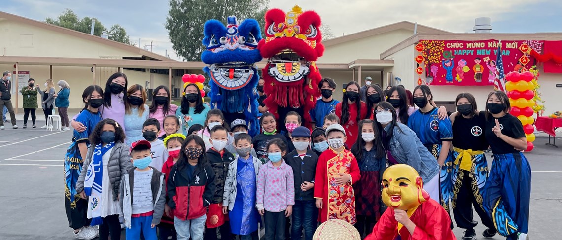 Students pose with Lion Dancers for Lunar New Year