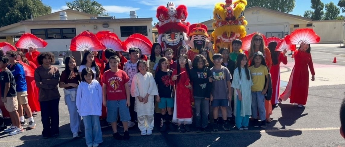 Students pose with Lion Dancers for Lunar New Year