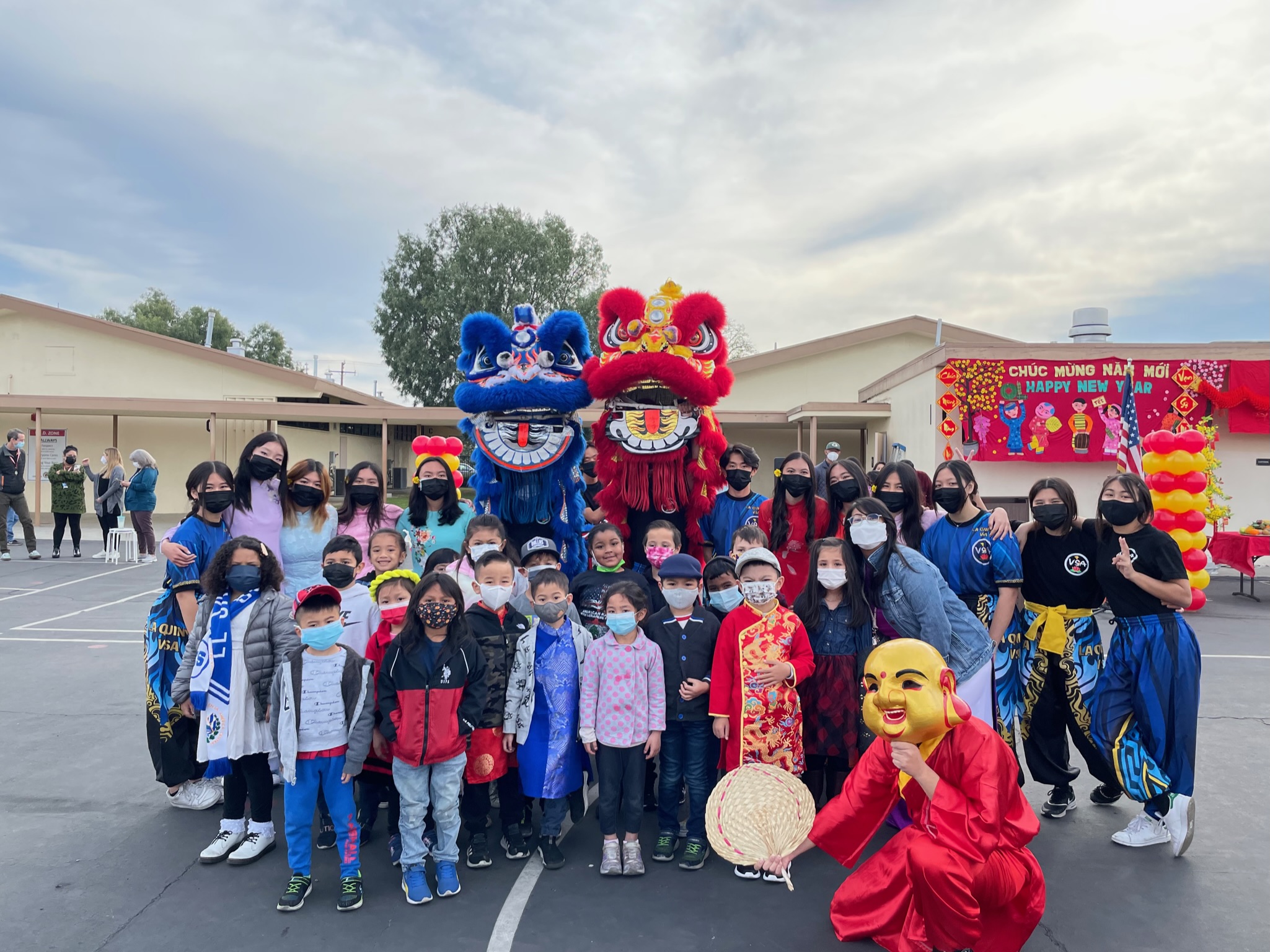 Students pose with Lion Dancers for Lunar New Year